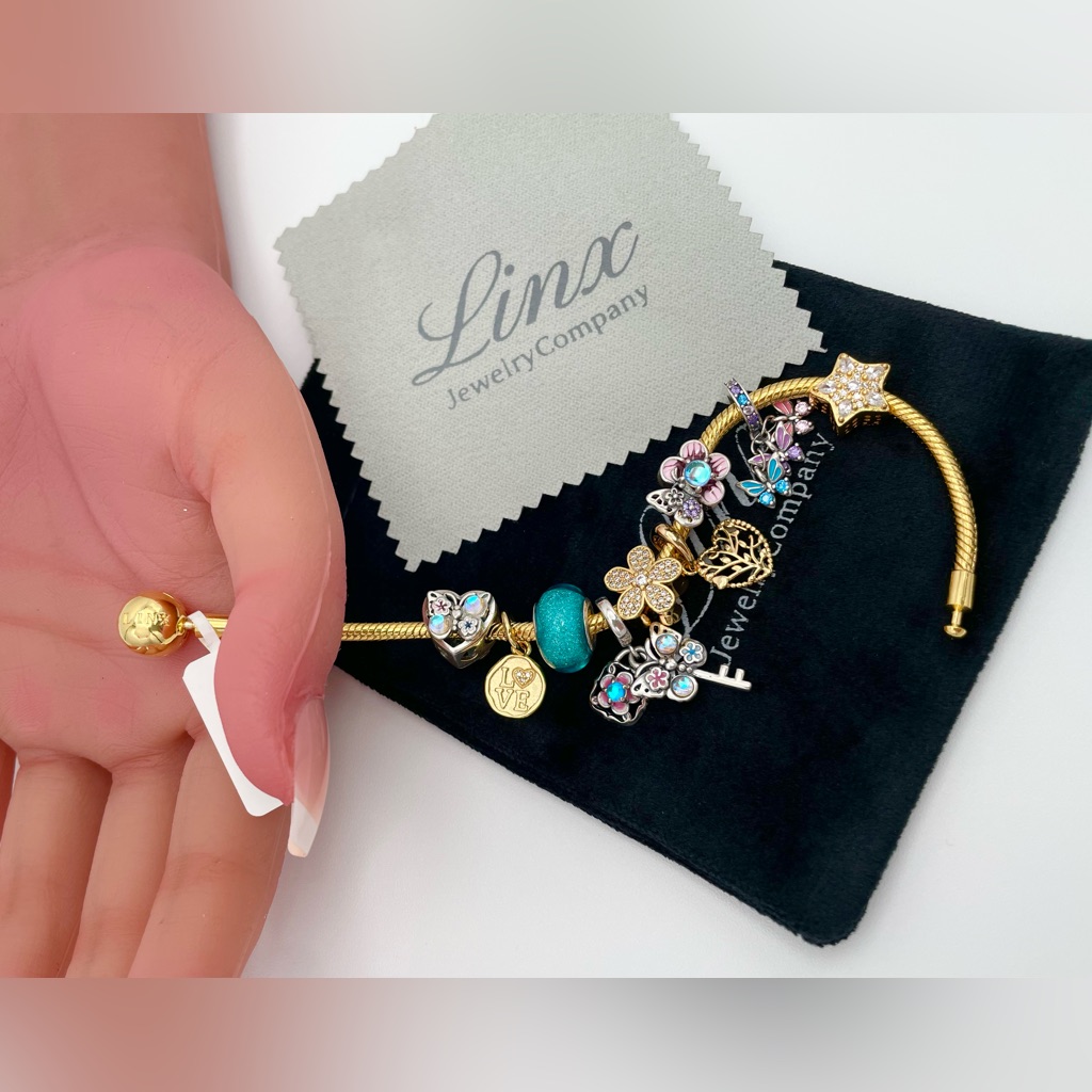 Linx Yellow Gold Bracelet With Gold Turquoise Pink And Silver Themed Charms